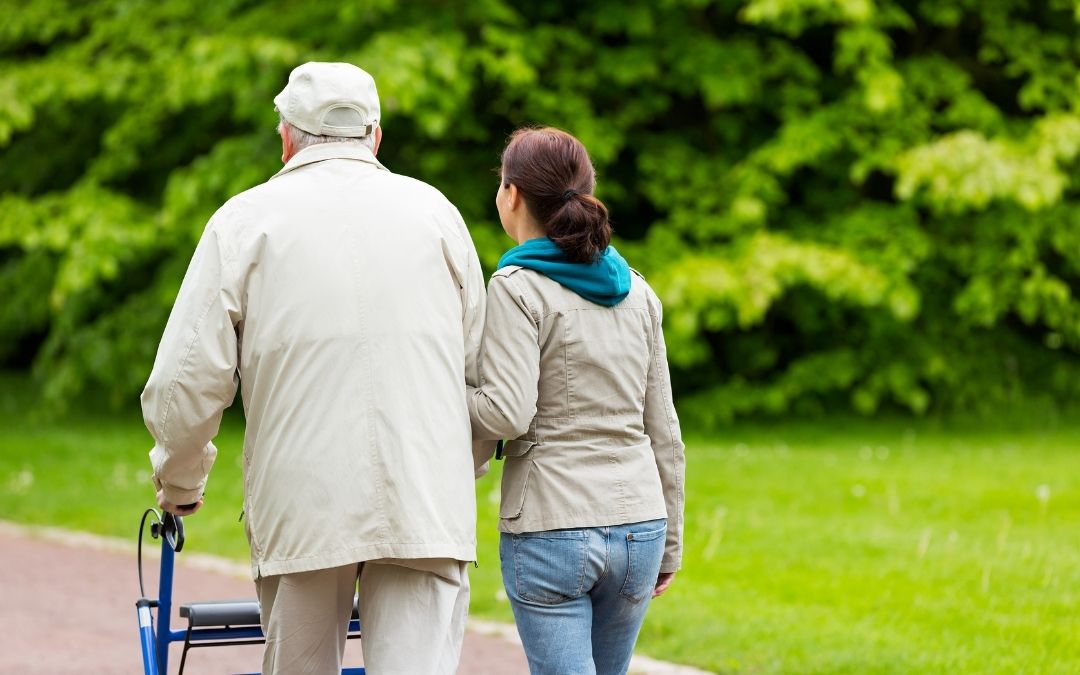 Senior Living: Adult child walking with elderly father