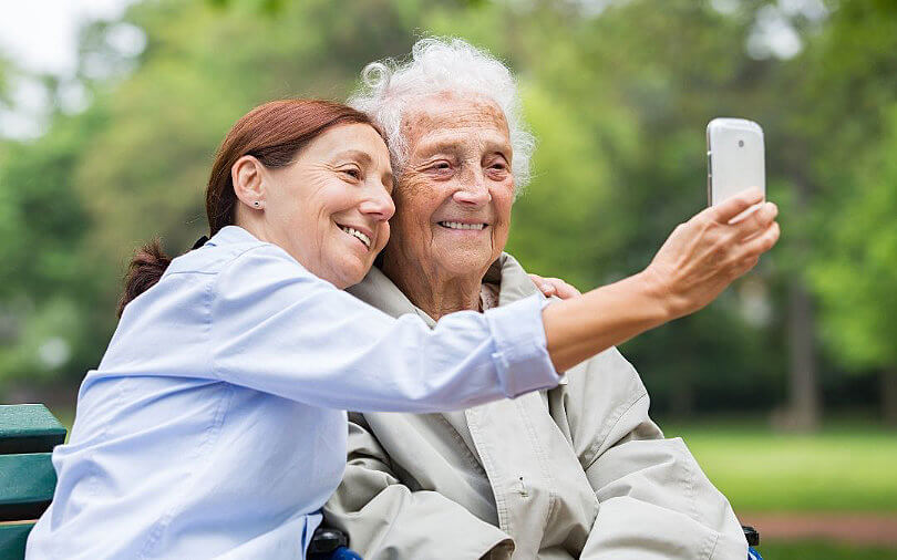 Mother and Daughter taking a selfie together at memory care facility