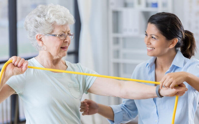 One-On-One Eldercare: Senior exercising with bands