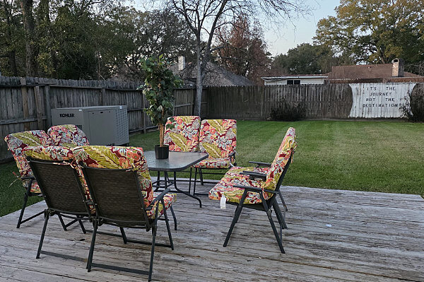 Back yard deck with table and chairs at an assisted living facility located in Houston, Texas